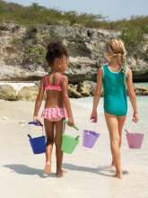 Piger går på stranden med scrunch buckets i forskellige farver