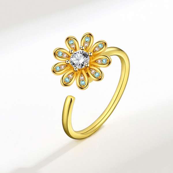 Fidgetring med blomst i guld – elegant og beroligende design

