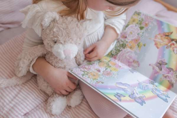 Katten Pickles læser i en bog samme med en pige