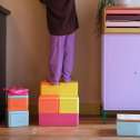 Barn står på byggeklodser fra Tomke startsæt – balancelegetøj til aktiv leg og sansestimulering


